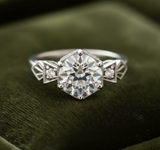 Art Deco engagement ring on dark olive green velvet