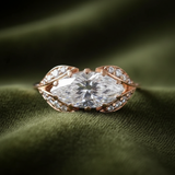 East-west marquise ring on dark olive green velvet