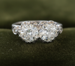 Two-stone diamond ring on dark olive green velvet